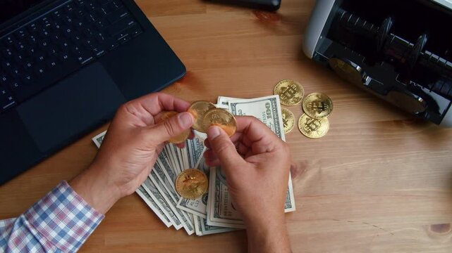 Hands are busy sorting cash and coins on a wooden desk, preparing for financial tasks as sunlight streams through a nearby window, creating a warm atmosphere