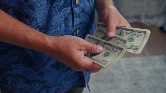 Hands skillfully arrange freshly minted bills, basking in warm sunlight. The feelings of excitement and hope linger in the air as the money is counted
