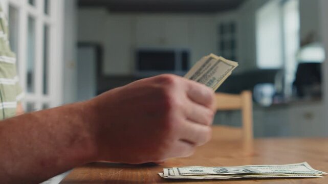 Hands delicately sort through crisp bills on a wooden table, sunlight dances in the cozy kitchen, revealing moments of thought and anticipation for what lies ahead