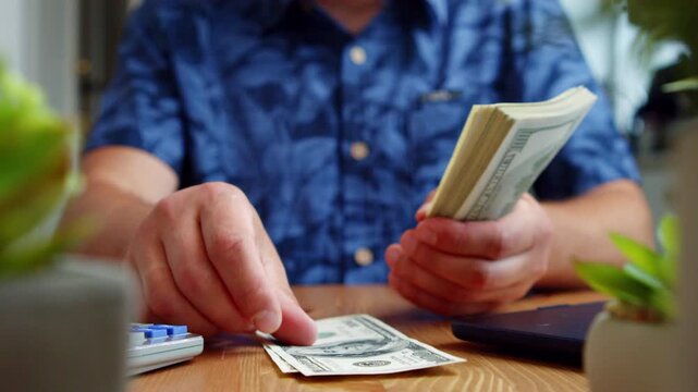 Hands attentively sort stacks of cash on a warm wooden table, surrounded by cheerful greenery and hints of summer adventure and friendship