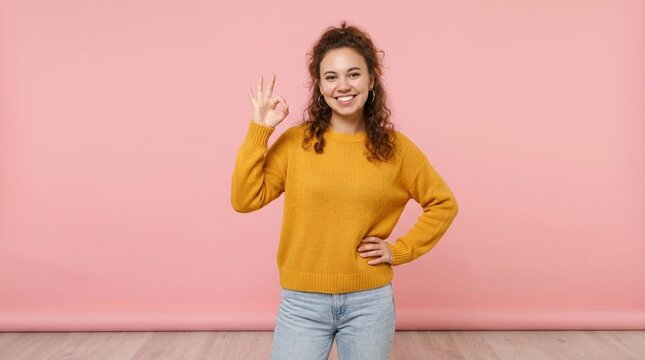 Joyful Woman Showing OK Sign with Smile &ndash; Positive Gesture Approval Concept on Pink Background
