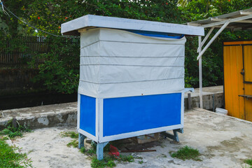 Naklejka premium Closed street food stall covered with white canvas tarpaulin