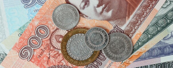 Cambodian riel money bills and coins on table. Cambodia cash of KHR currency © Larysa