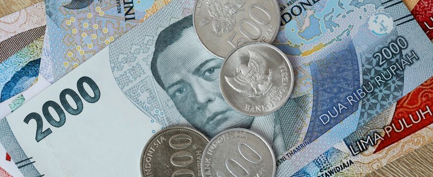 Indonesian rupiah money bills and coins on table. Indonesia cash of IDR currency