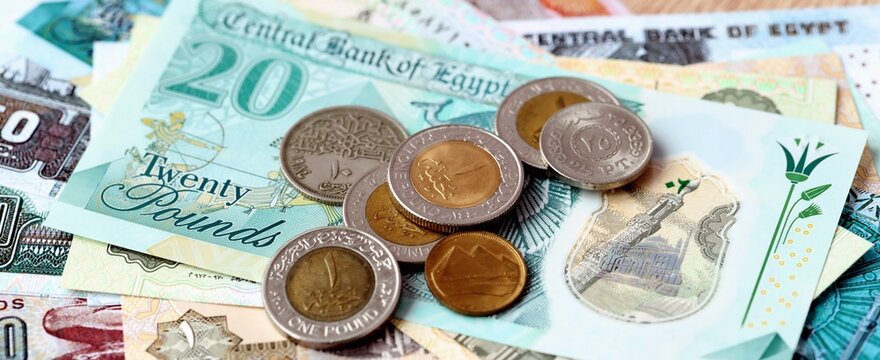 Egyptian pound money bills and coins on table. Egypt cash of EGP currency close up
