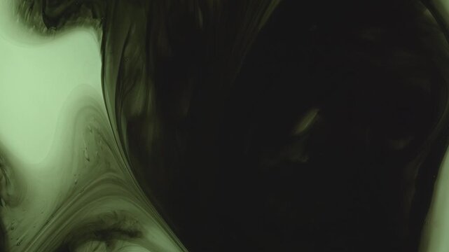 Abstract background of dark green and black ink swirling underwater. Mesmerizing fluid motion creates a moody, smoky organic pattern. Perfect for dramatic overlays.