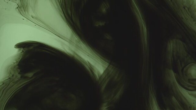 Abstract background of dark green and black ink swirling underwater. Mesmerizing fluid motion creates a moody, smoky organic pattern. Perfect for dramatic overlays.