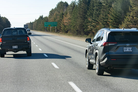 Quebec, Canada, 24 April 2026 : Vehicles, including a Toyota Tacoma pickup truck and a Toyota RAV SUV, drive on a multi-lane highway.
