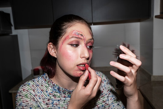 Redhead character applying lipstick with a dramatic gesture under direct flash