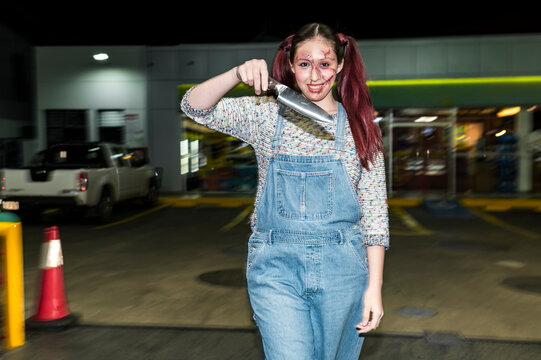 Menacing costumed character raising a knife under direct flash at a night gas station