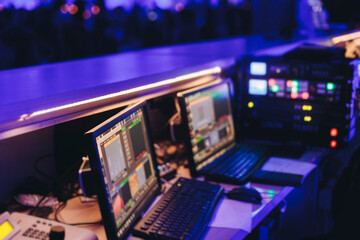 Lighting engineer operator working on mixing console workplace during live event concert on stage show broadcast, light mixer controller panel, sound technician workplace with professional equipment © tsuguliev