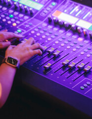 Lighting engineer operator working on mixing console workplace during live event concert on stage show broadcast, light mixer controller panel, sound technician workplace with professional equipment © tsuguliev
