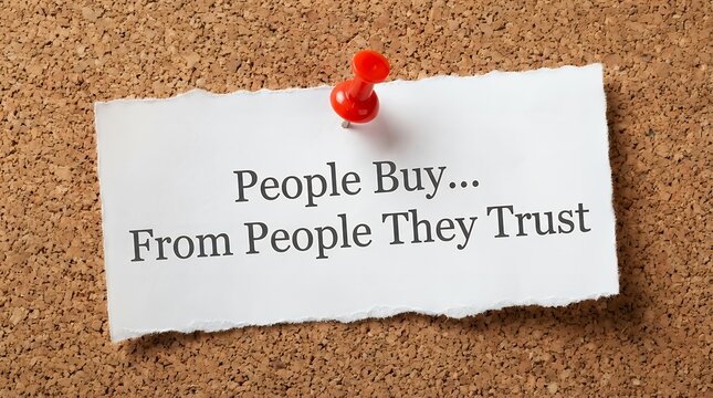 A torn piece of paper pinned to a corkboard displays the text People Buy From People They Trust in black serif font buying business relationship communication confidence credibility