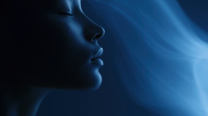 Obraz premium Calm face illuminated by subtle blue ambient glow with flowing holographic smoke on dark background, elegant minimal composition