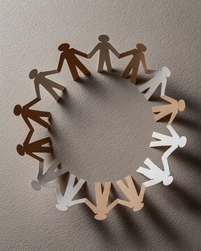Paper cutouts of diverse people holding hands in a circle, symbolizing unity and community.