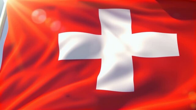 Swiss flag waving in the wind with bright sun flare