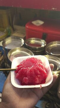 Sweet Red Syrup Poured On Shaved Ice Gola Chuski In Bowl (Close Up)