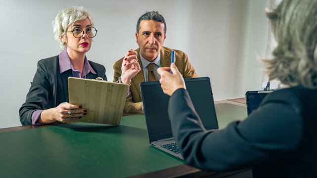 Financial advisor explaining contract terms to clients during office consultation