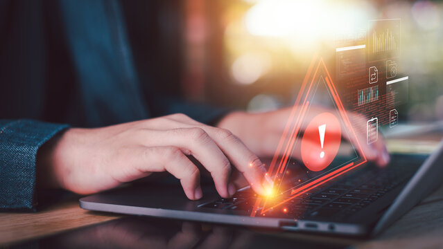 Cybersecurity analyst monitoring malware attack alerts on laptop with data breach warning, network protection, cyber threat detection, ransomware risk, and digital security monitoring.