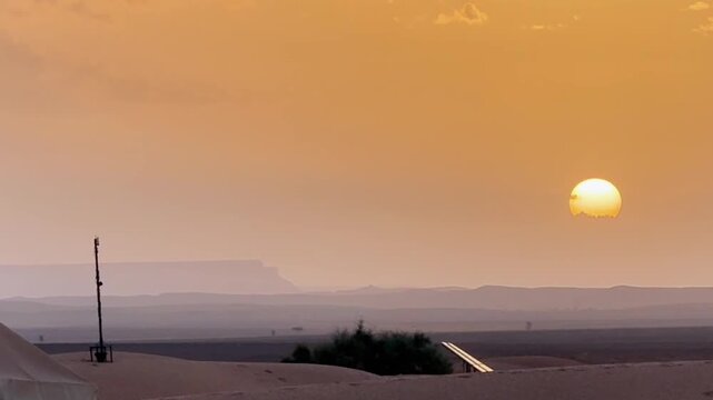 Golden Hour Sunset Over Sahara Desert Camp in Morocco