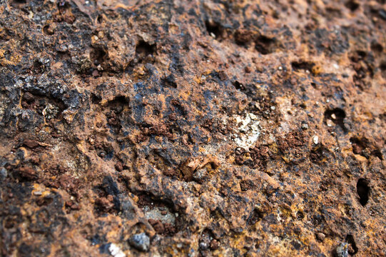 Porous laterite rock surface texture with natural reddish brown color
