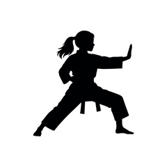Silhouette of a young girl in a karate stance practicing martial arts © WanchiJeni