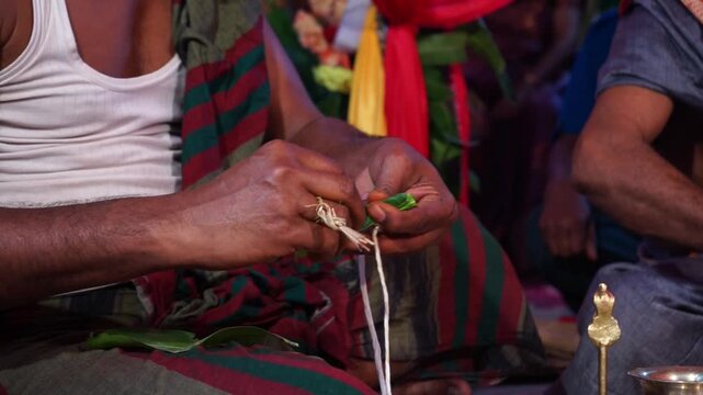 Close-up footage of bride and groom hands participating in traditional Hindu wedding rituals during a marriage ceremony in India. The scene captures sacred customs, ceremonial offerings