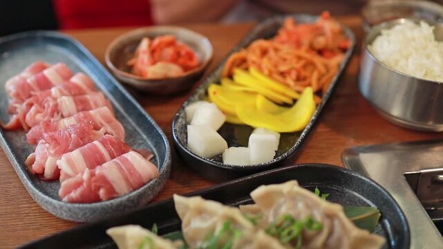 White daikon, banchan, and other Korean appetizers in a restaurant. Fermented food, traditional Asian meals.