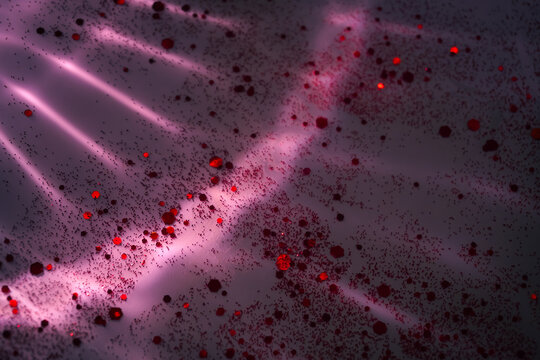 Vibrant pink reflections and sparkling red glitter shimmering in the night, creating a glamorous luxury texture perfect for festive backgrounds and commercial design.