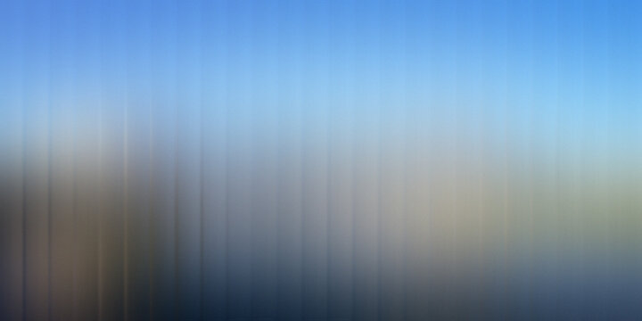 Soft abstract blur of vertical lines against a light sky background