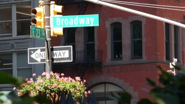 New York City Broadway street sign on Manhattan, United States. Urban road sign in american city. Traffic sign in Midtown. Building architecture in Flatiron district. Crossroad with 5 fifth avenue.