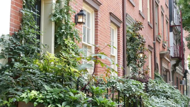 New York City urban residential buildings architecture, Manhattan classic street, Greenwich village, United States of America. Typical red brick house in NYC, real estate property in USA. West village