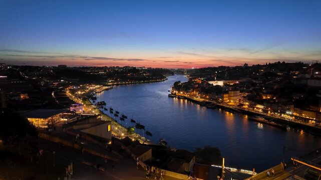 Famous Porto cityscape with the Douro river and Ribeira district illuminated at sunset