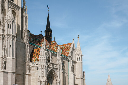 Close up of Gothic cathedral architecture showing vibrant patterned ceramic tile roof