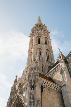 Low angle view of ornate Gothic cathedral spire and detailed stone carvings
