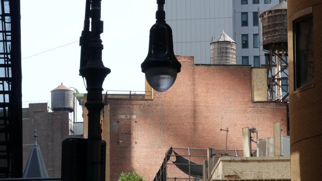 New York City urban building architecture, Manhattan rooftop, United States of America. Water tower on roof. Classic water tanks and lantern.