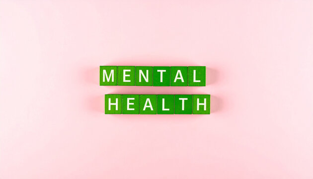 Mental health words written with green scrabble blocks on a pink background