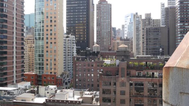 New York City Midtown East urban residential buildings, red brown brick architecture, Manhattan rooftop, United States of America. Water towers on roof. Cityscape with classic water tanks, Turtle Bay.