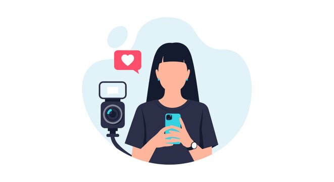 A young woman holds a smartphone to record content while a specialized camera with a flash attachment sits nearby in a bright, modern digital media creation environment.