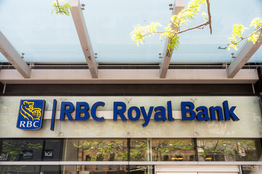 Toronto, Canada - May 26, 2026: RBC Royal Bank branch exterior with glass canopy and tree reflections