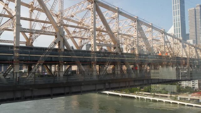 New York City Queensboro bridge architecture from Queens to Manhattan Midtown, United States. Urban public transport, tramway to Roosevelt island over East River. Metallic bridge road to East Side.