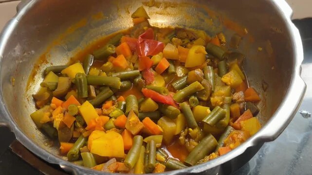 Vegetable dry curry in a pressure cooker