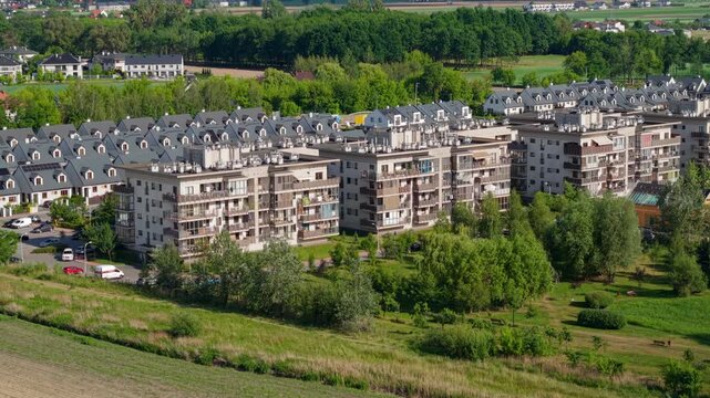 An aerial view of a newly built estate of single-family houses in rows on the outskirts of a large city, real estate market, prices and use of space by developers.
