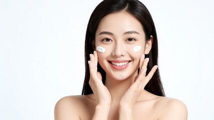Fototapeta premium Radiant Glow: A beautiful Asian woman with flawless skin applies moisturizer, her smile radiating confidence and natural beauty.