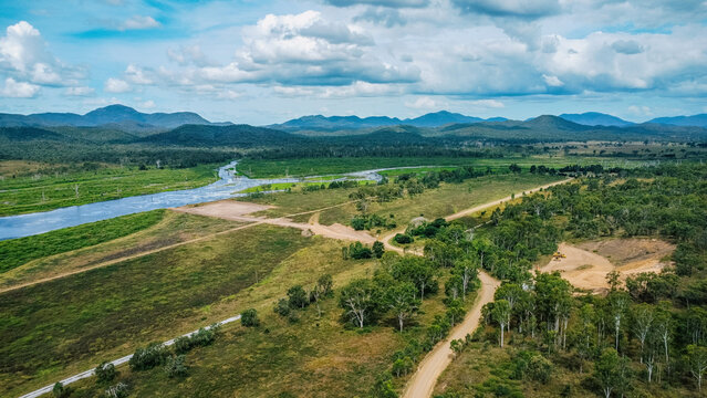 Aerial view of a winding river cutting through a lush, green landscape