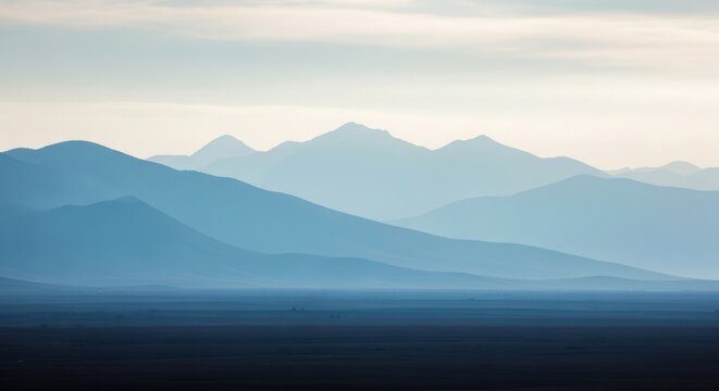 Distant Layered Blue Mountains Under a Hazy Sky