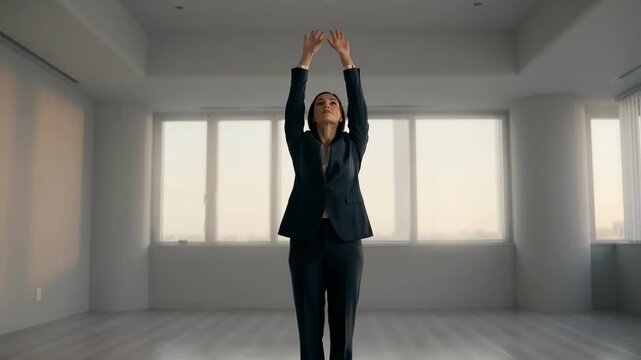 Businesswoman performing a mindful stretching routine in an empty office. Embracing a minimalist career path.