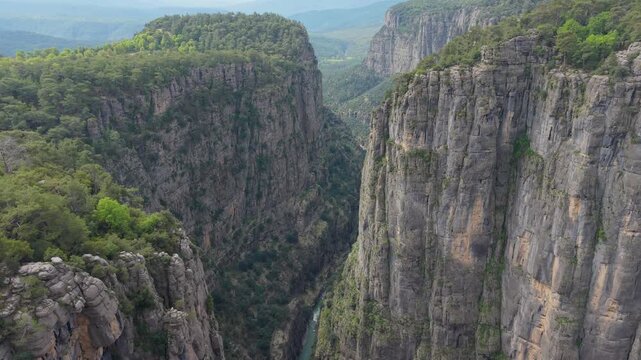 Witness the stunning cliffs and lush greenery of Tazi Canyon, showcasing the natural wonder of Koprulu Canyon Milli in Turkey. Perfect for adventure seekers and nature lovers alike.