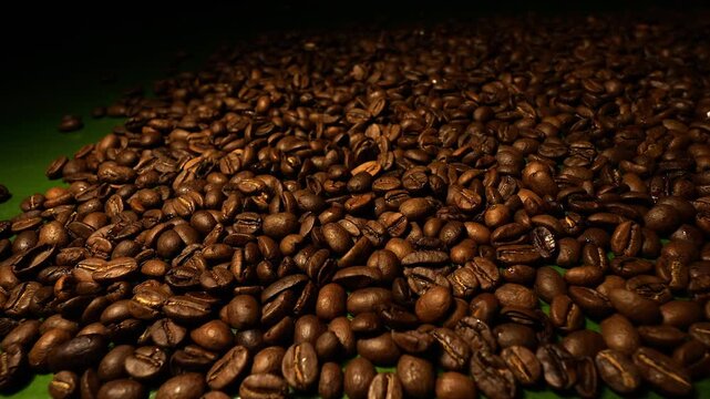50p side view slider shot moving across roasted coffee beans