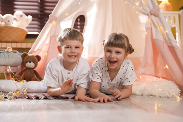Little girl and boy near wigwam at home © New Africa